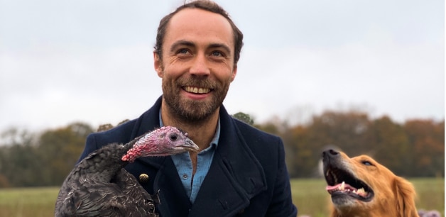 James Middleton poses with his golden retriever Mabel and a free range turkey