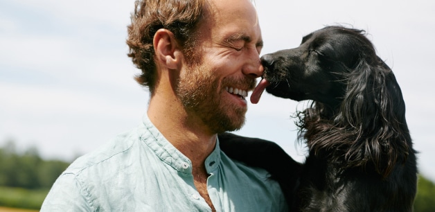 James middleton laughing being licked by his black cocker spaniel