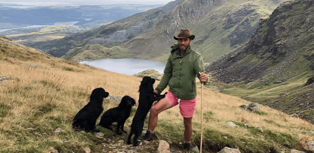 James Middleton on mountain with his dogs hiking
