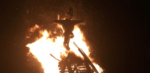a model of guy fawkes in front of a raging fire on bonfire night