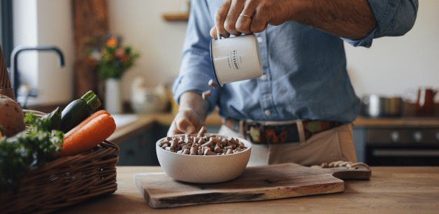 James Middleton pouring healthy Freeze-dried raw dog food into a bowl