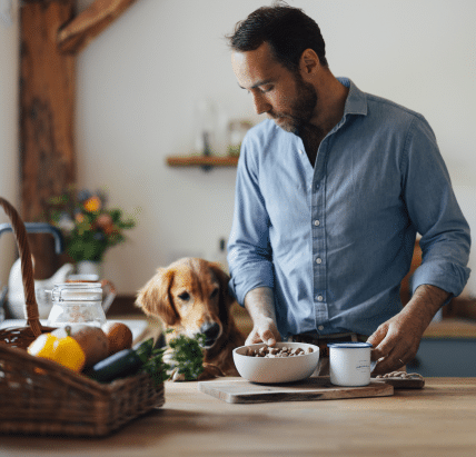 James Middleton with golden retriever and bowl of freeze-dried raw food