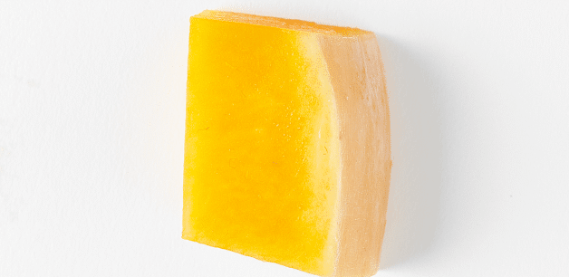 A small cube of Pumpkin on a white background