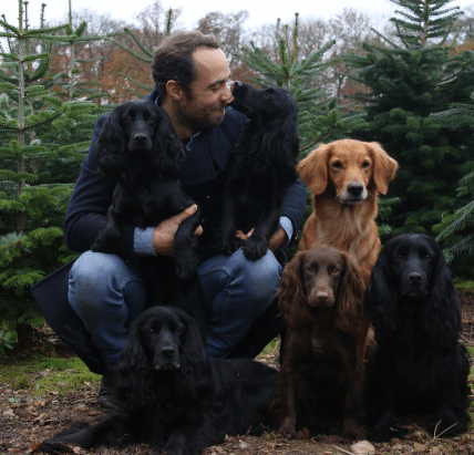 James middleton with his dogs infront of christmas trees