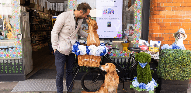James standing next to bike with his dogs